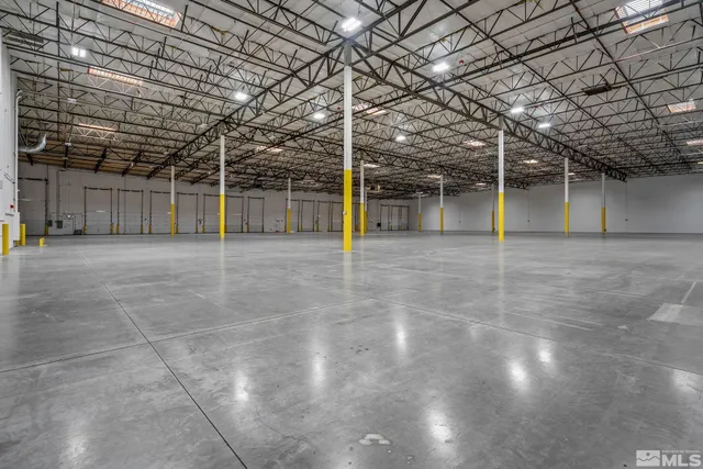 a view of a water heater room with wooden floor
