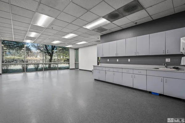 a kitchen with stainless steel appliances granite countertop a stove a sink dishwasher and a microwave oven with cabinets