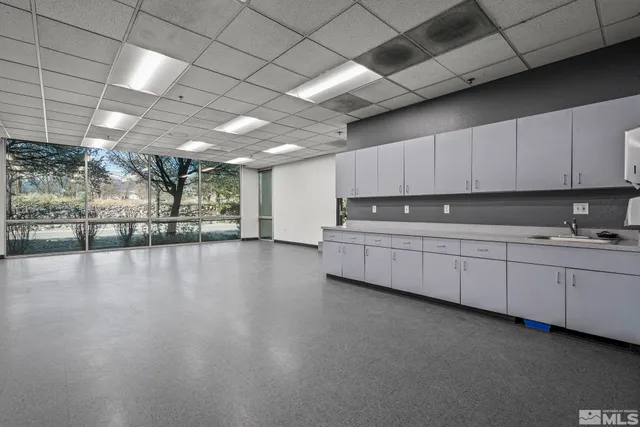 a kitchen with stainless steel appliances granite countertop a stove a sink dishwasher and a microwave oven with cabinets