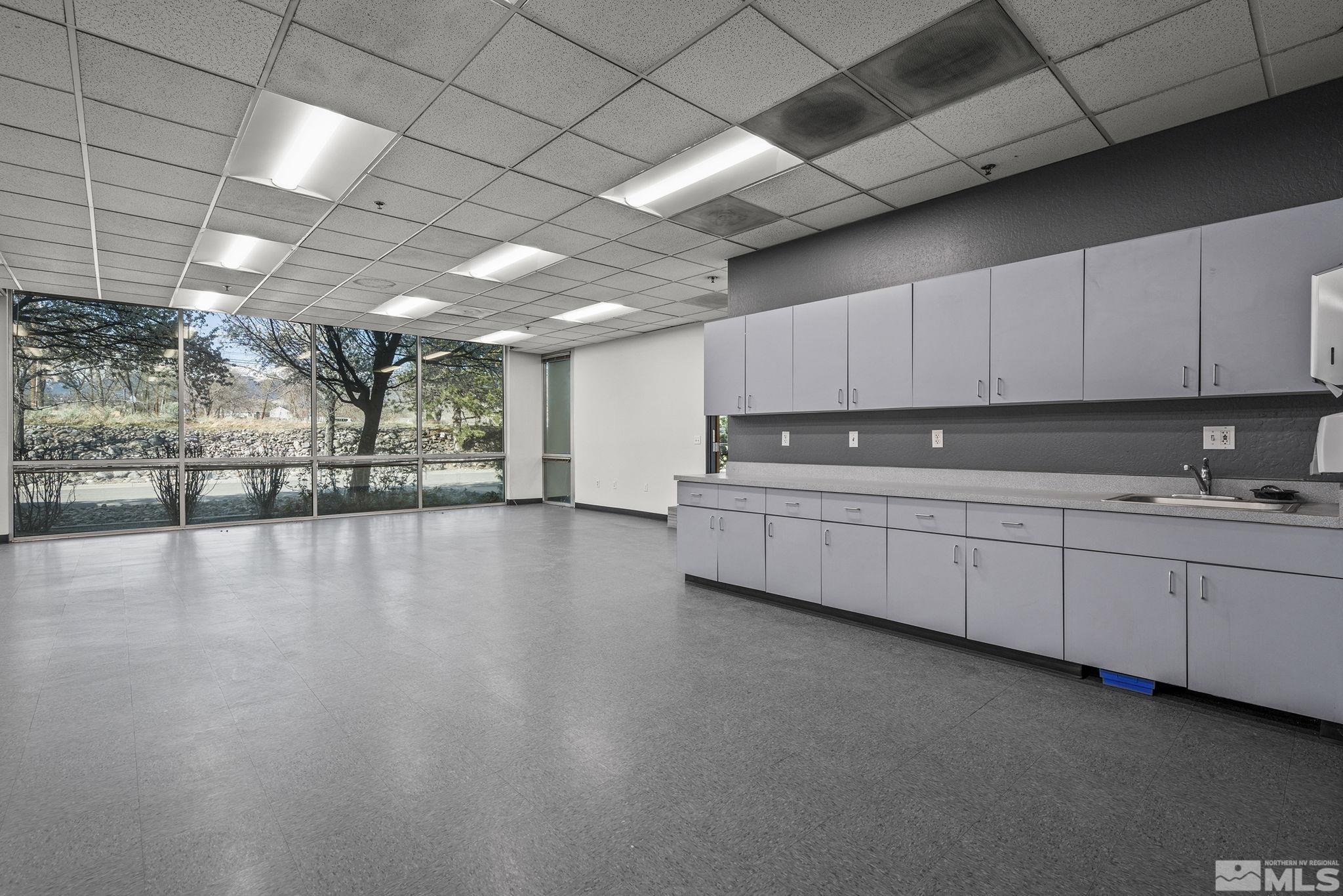 12815 Old Virginia Road Reno, NV 89521 - Photo 10 of 20 a kitchen with stainless steel appliances granite countertop a stove a sink dishwasher and a microwave oven with cabinets