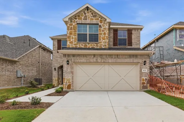 a front view of a house with garage