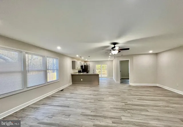 a kitchen with stainless steel appliances granite countertop a refrigerator stove top oven and sink