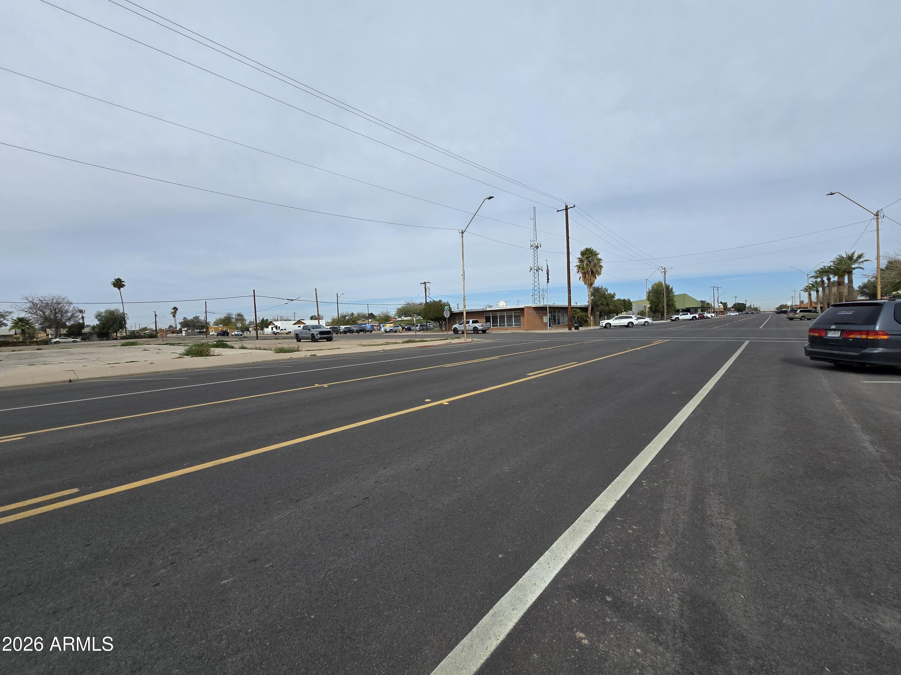 514 North Main Street, Unit 12 Eloy, AZ 85131 - Photo 4 of 10 a view of a city street with two cars parked on the road