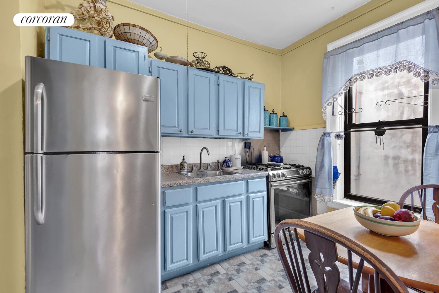 423 15th Street, Unit 4D Brooklyn, NY 11215 - Photo 3 of 7 a kitchen with stainless steel appliances granite countertop a refrigerator a sink dishwasher a stove with wooden cabinets and floor