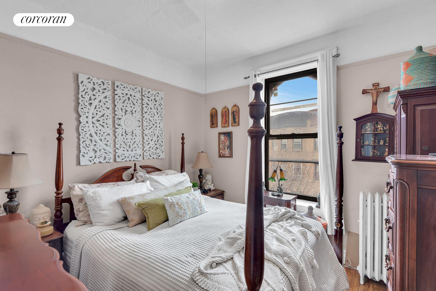 423 15th Street, Unit 4D Brooklyn, NY 11215 - Photo 4 of 7 a bedroom with a large bed and a tv
