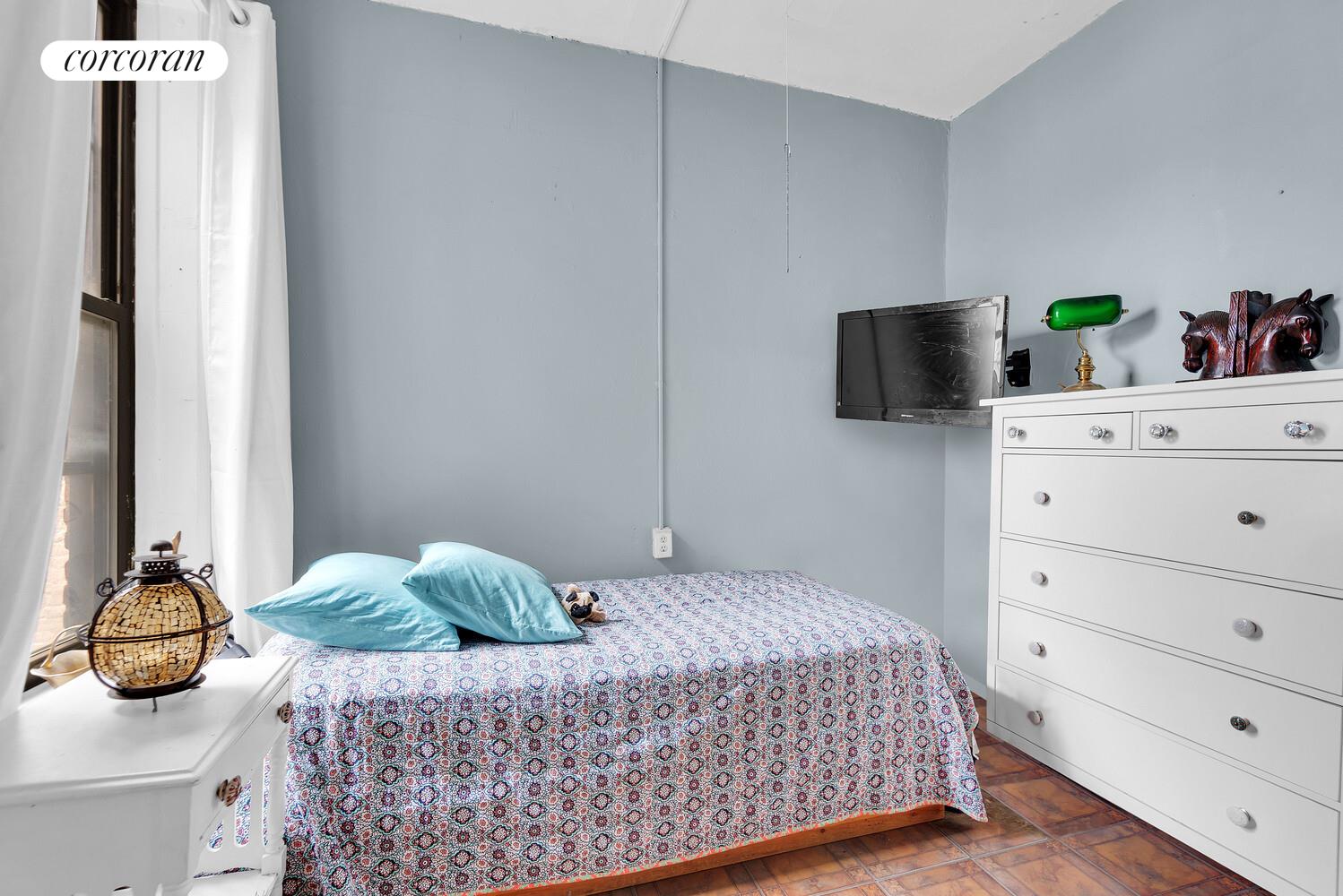 423 15th Street, Unit 4D Brooklyn, NY 11215 - Photo 5 of 7 a bedroom with a bed and flat screen tv