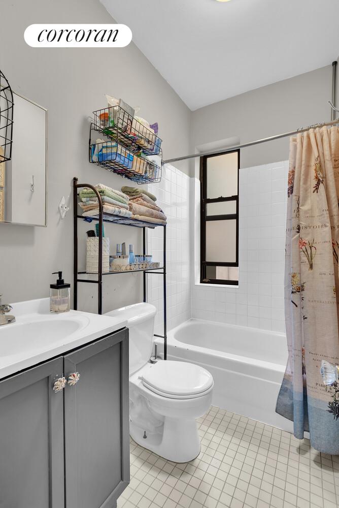 423 15th Street, Unit 4D Brooklyn, NY 11215 - Photo 6 of 7 a bathroom with a sink a toilet and shower