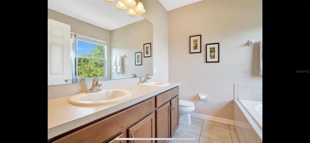 8174 Enchantment Drive, Unit 1601 Windermere, FL 34786 - Photo 12 of 21 a bathroom with a sink toilet and a mirror