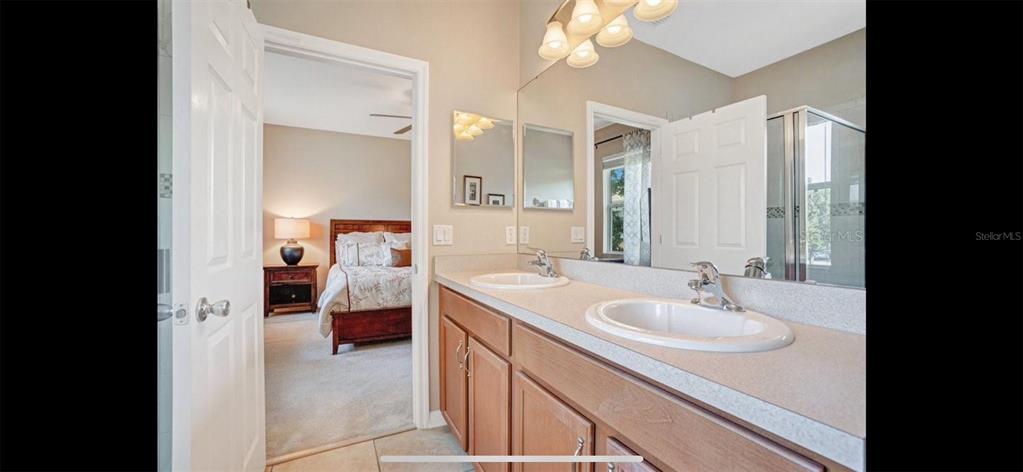 8174 Enchantment Drive, Unit 1601 Windermere, FL 34786 - Photo 13 of 21 a en suite bathroom with a sink and a mirror