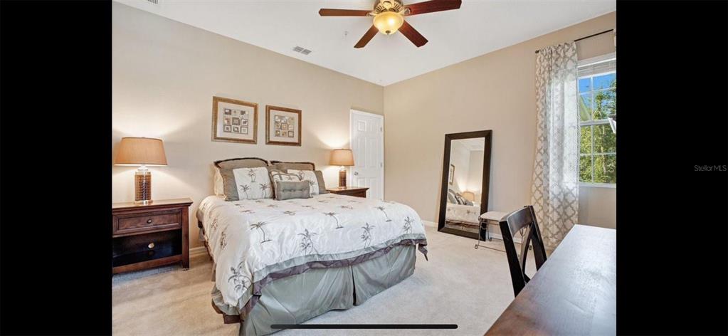 8174 Enchantment Drive, Unit 1601 Windermere, FL 34786 - Photo 16 of 21 a bedroom with a bed and a chandelier