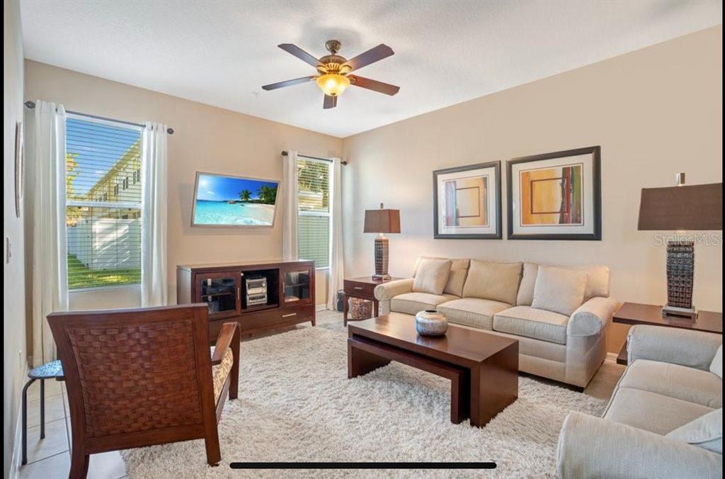 8174 Enchantment Drive, Unit 1601 Windermere, FL 34786 - Photo 4 of 21 a living room with furniture a rug and a window