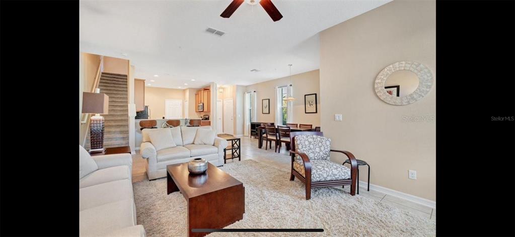 8174 Enchantment Drive, Unit 1601 Windermere, FL 34786 - Photo 5 of 21 a living room with furniture and wooden floor