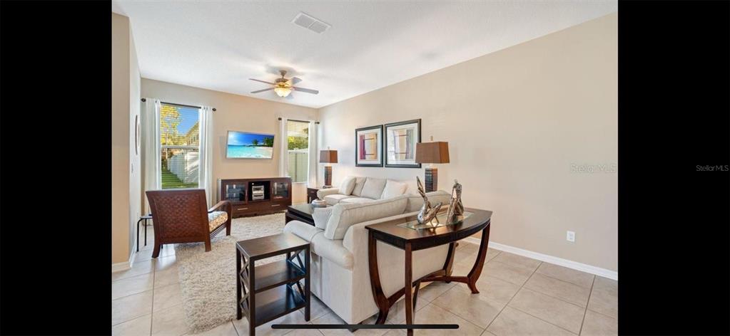 8174 Enchantment Drive, Unit 1601 Windermere, FL 34786 - Photo 6 of 21 a living room with furniture and a fireplace