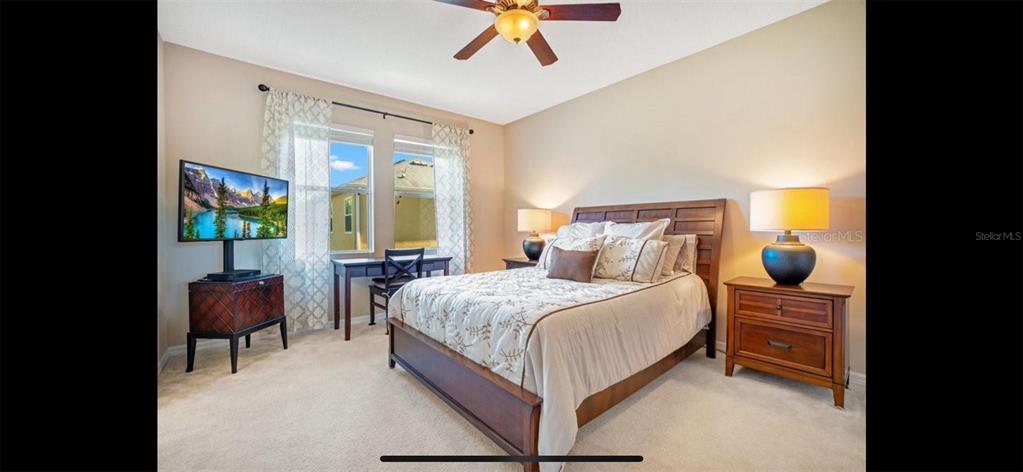 8174 Enchantment Drive, Unit 1601 Windermere, FL 34786 - Photo 10 of 21 a bedroom with a bed and a chandelier