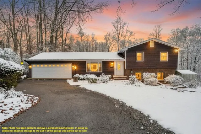 a view of a house with snow on the road