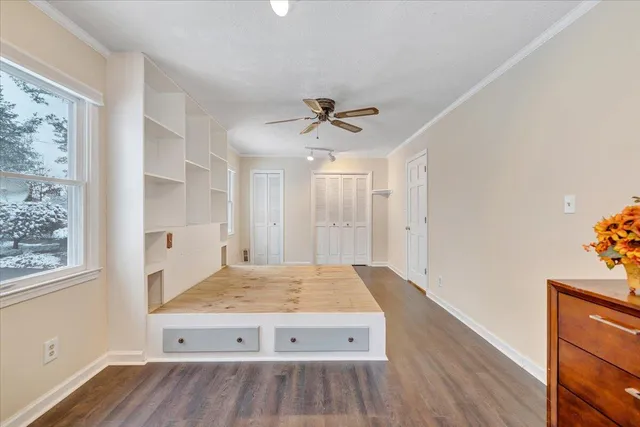 a view of empty room with wooden floor and fireplace
