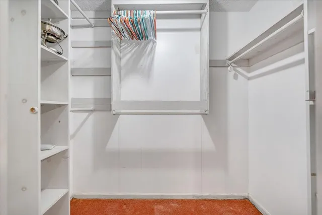 a view of a house with wooden chairs and wooden fence