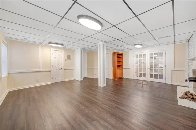 a front view of a house with a yard covered with snow
