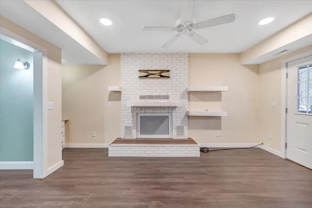 a wooden bench covered with snow in front of house