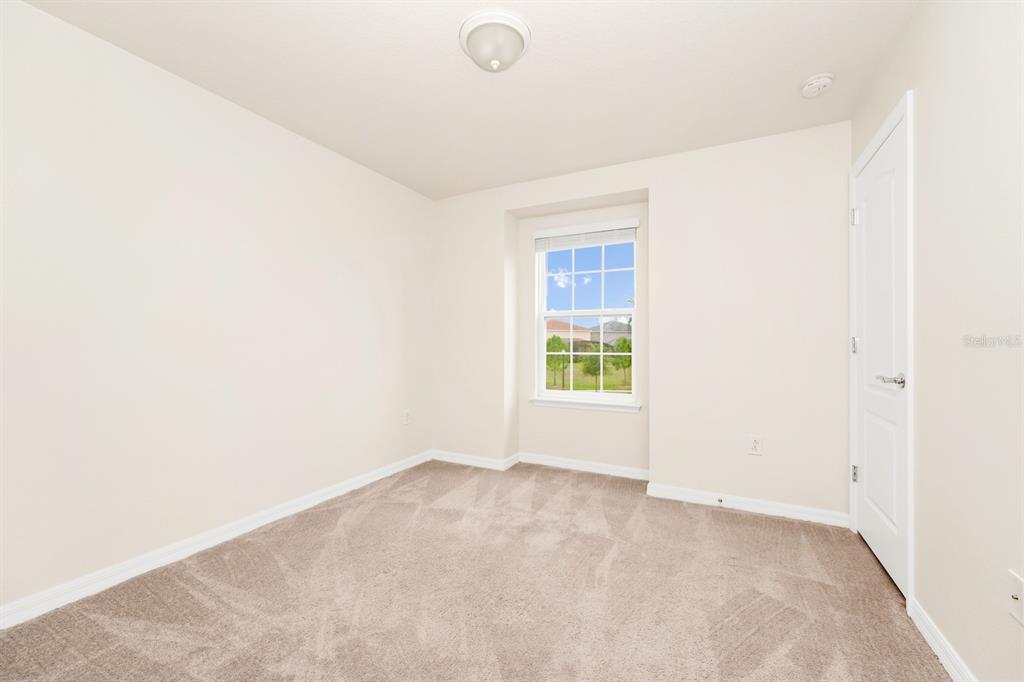 7513 Oak Spring Lane Davenport, FL 33837 - Photo 17 of 40 a view of an empty room with a window