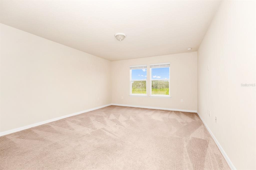 7513 Oak Spring Lane Davenport, FL 33837 - Photo 23 of 40 an empty room with windows