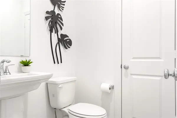 a white toilet sitting next to a bathroom sink