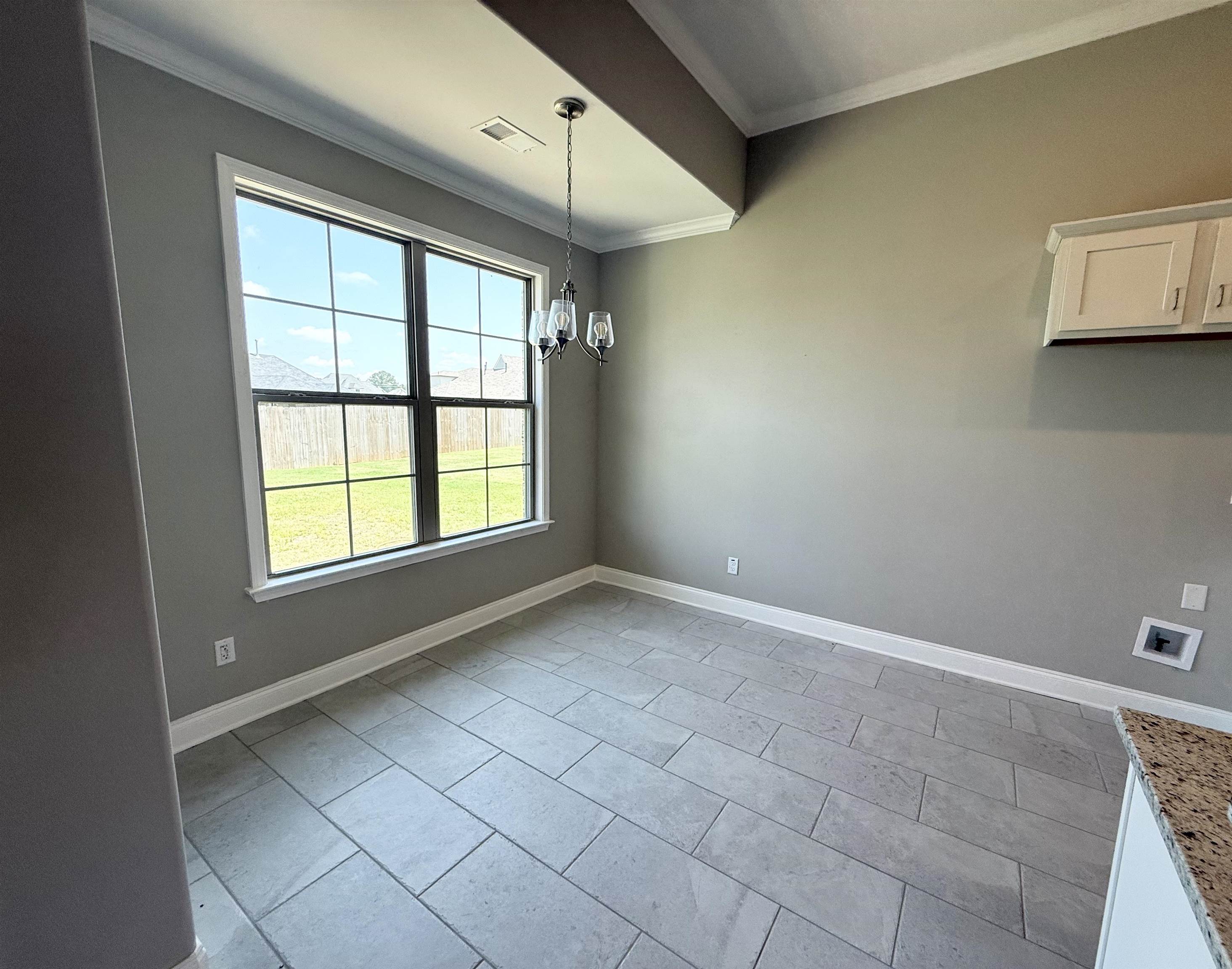 115 Misty Rdg Loop Oakland, TN 38060 - Photo 8 of 29 Breakfast area featuring ornamental molding, light tile patterned floors, and a chandelier