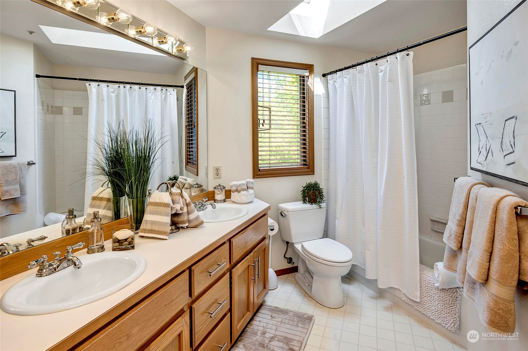 4516 Northeast 26th Court Renton, WA 98059 - Photo 21 of 28 a bathroom with a double vanity sink toilet and a mirror