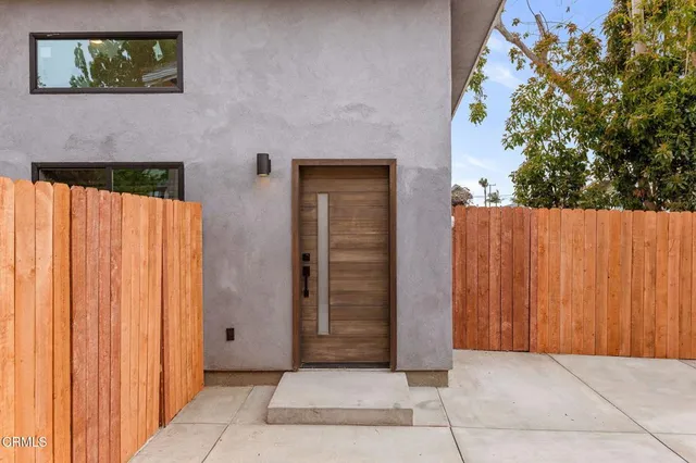 a view of backyard with tub and trees in the background
