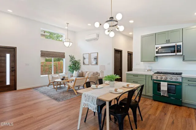 a view of a dining room with furniture and wooden floor