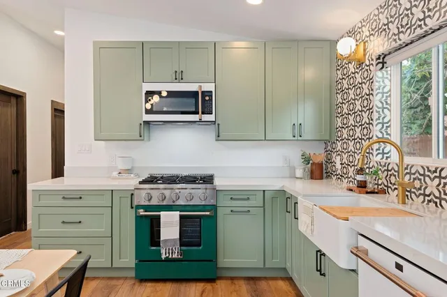 a kitchen with a sink cabinets and a wooden floor