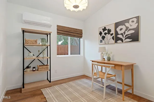 a view of workspace with window and wooden floor