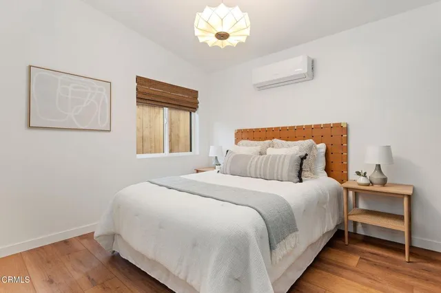 a bedroom with a bed and wooden floor