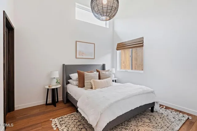 a bedroom with a bed and a mirror