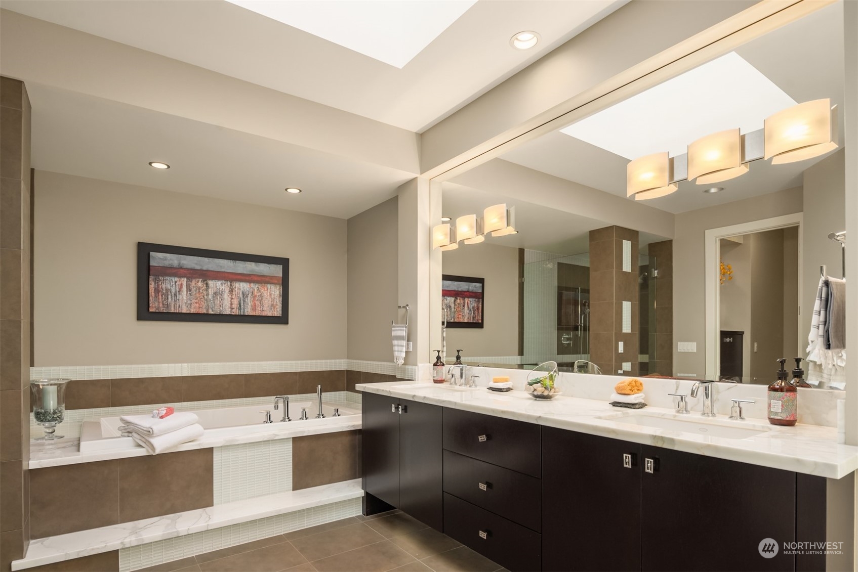 1019 North 42nd Place Renton, WA 98056 - Photo 12 of 33 a bathroom with a sink a large mirror and a bathtub
