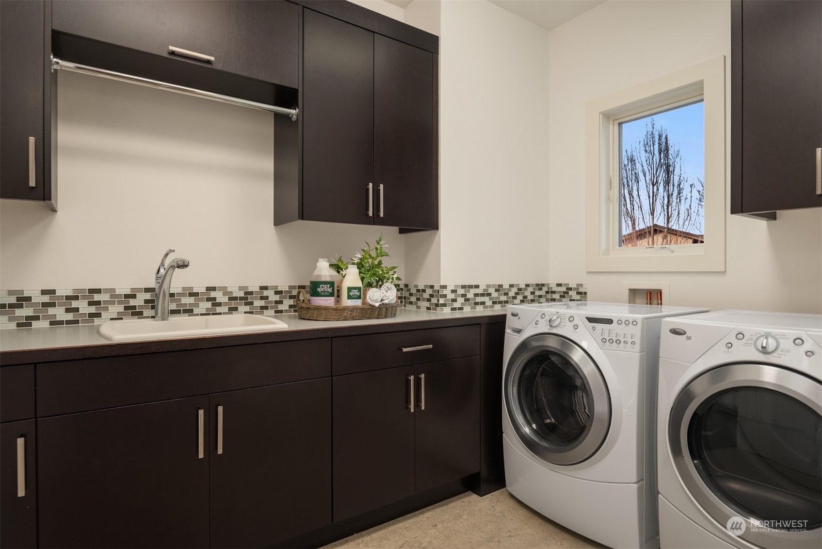 1019 North 42nd Place Renton, WA 98056 - Photo 19 of 33 a utility room with cabinets and washer