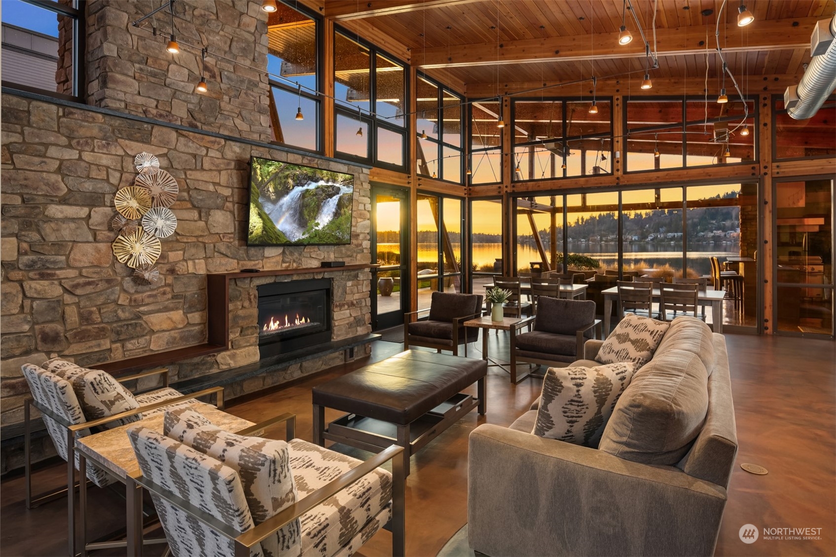 1019 North 42nd Place Renton, WA 98056 - Photo 27 of 33 a living room with furniture a fireplace and a floor to ceiling window