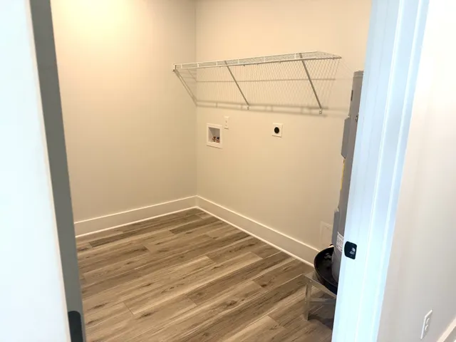 a view of a room with wooden floor