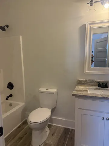 a bathroom with a toilet a sink and bathtub