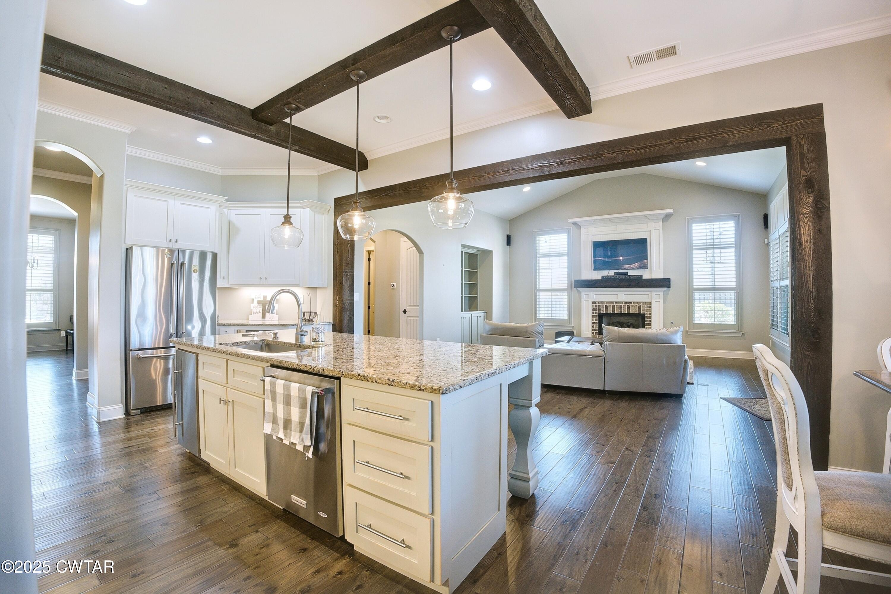 963 Ashport Road Jackson, TN 38305 - Photo 11 of 51 a kitchen with stainless steel appliances kitchen island granite countertop a stove and a refrigerator