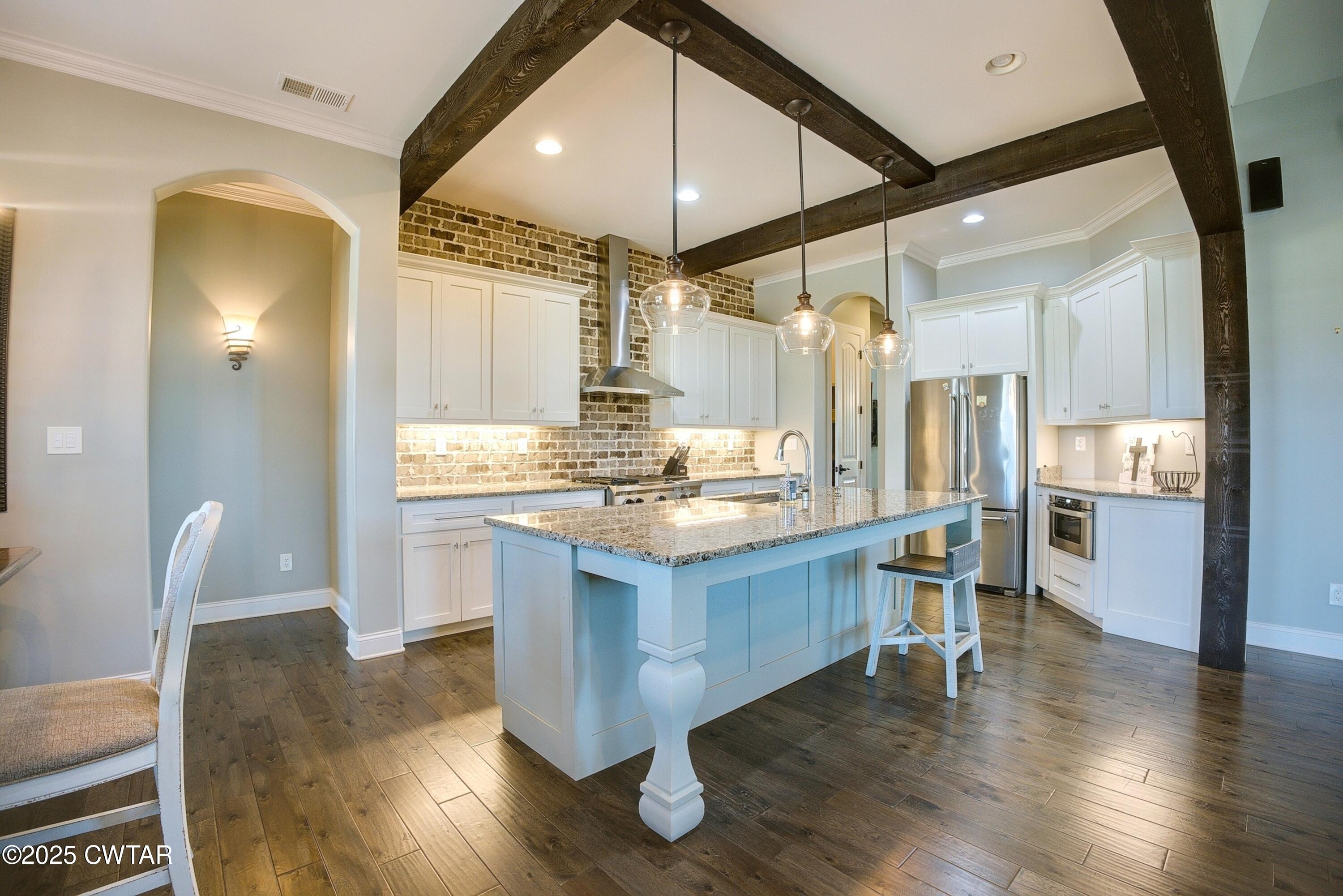 963 Ashport Road Jackson, TN 38305 - Photo 12 of 51 a kitchen with kitchen island granite countertop wooden floors and a sink
