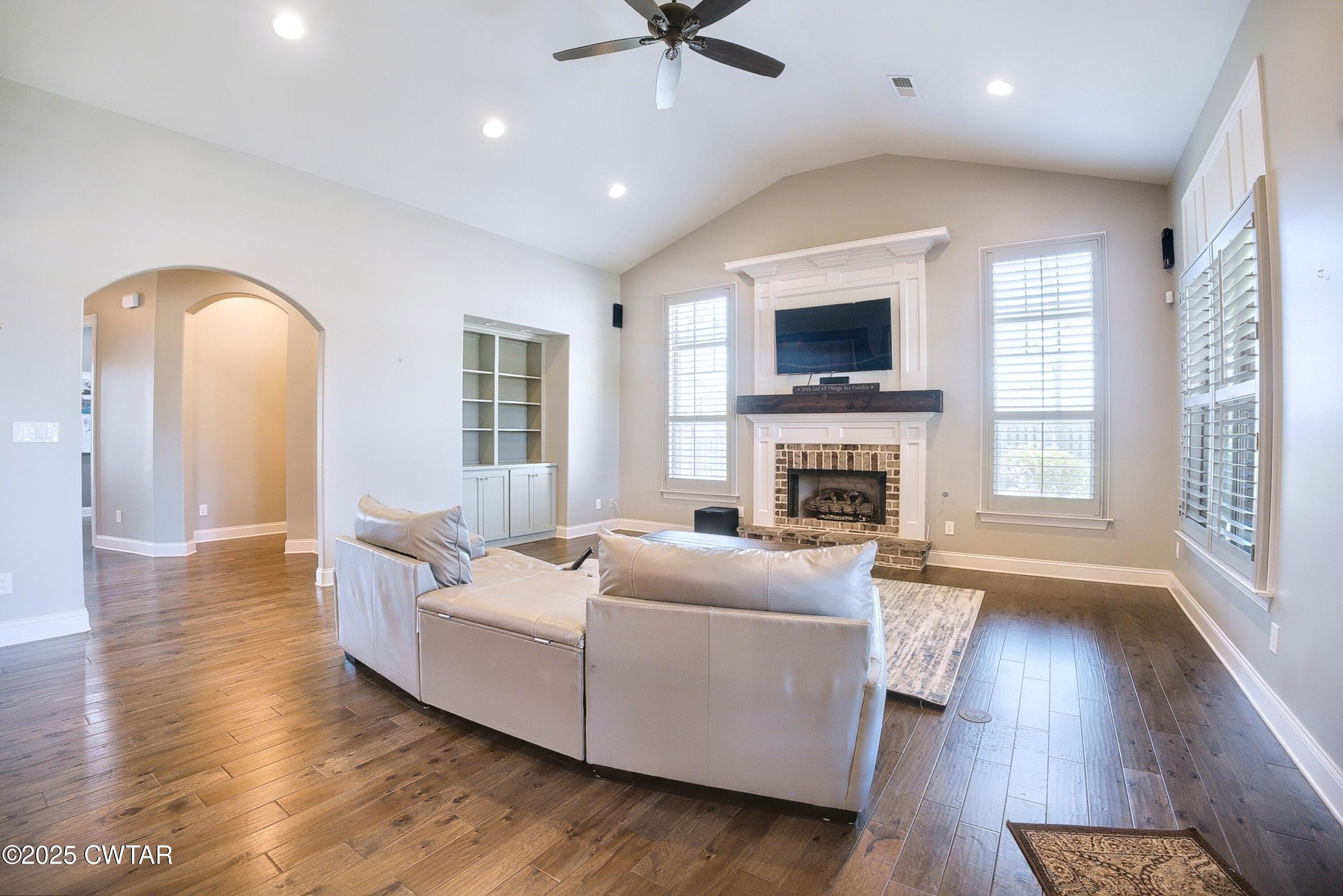 963 Ashport Road Jackson, TN 38305 - Photo 18 of 51 a living room with furniture fireplace and flat screen tv