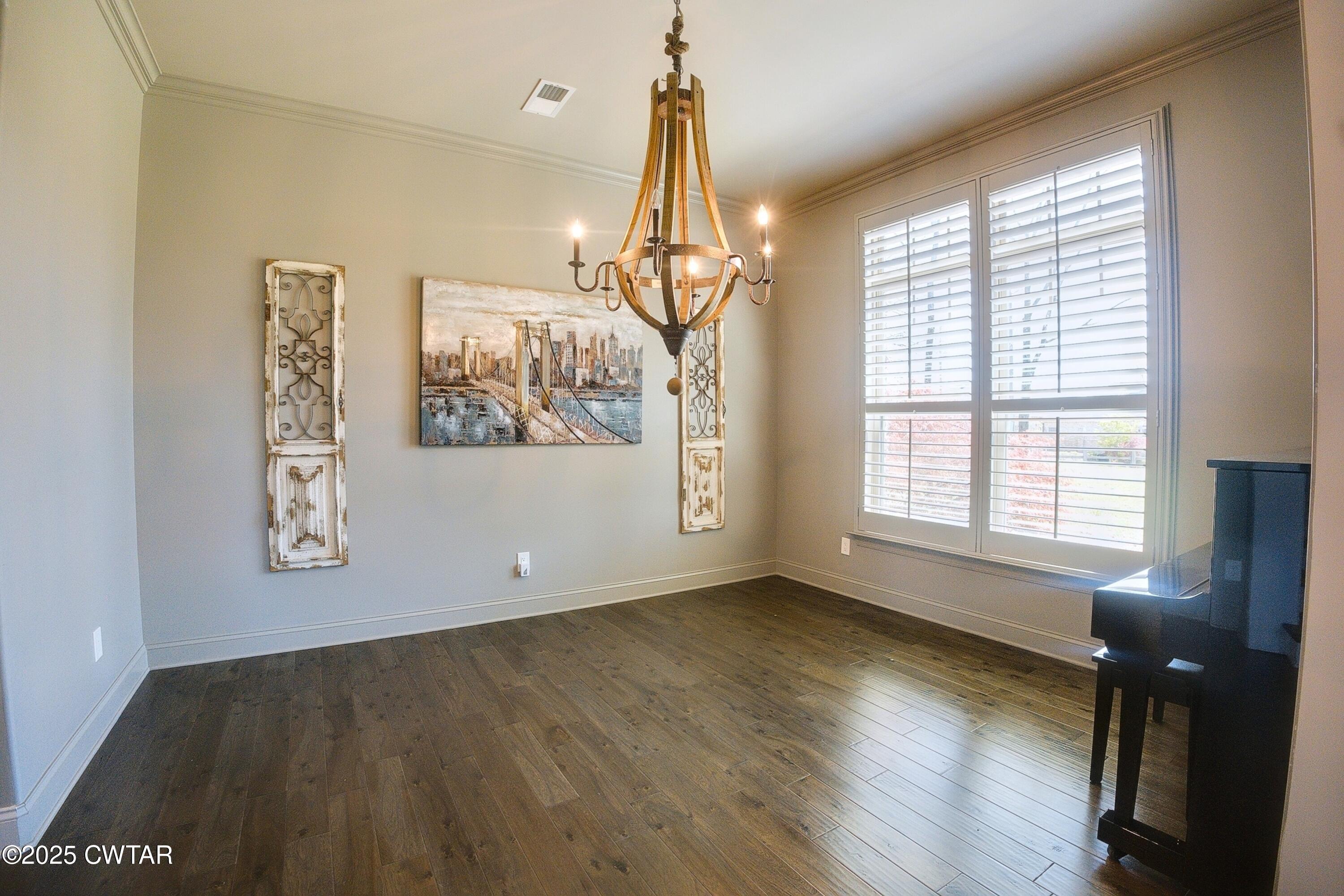 963 Ashport Road Jackson, TN 38305 - Photo 22 of 51 a view of empty room with wooden floor and fan