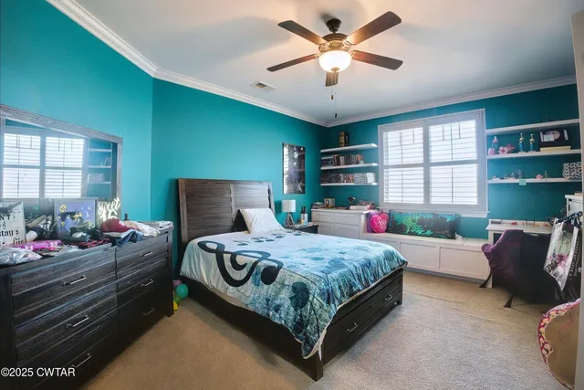 a bedroom with a bed chandelier and a window