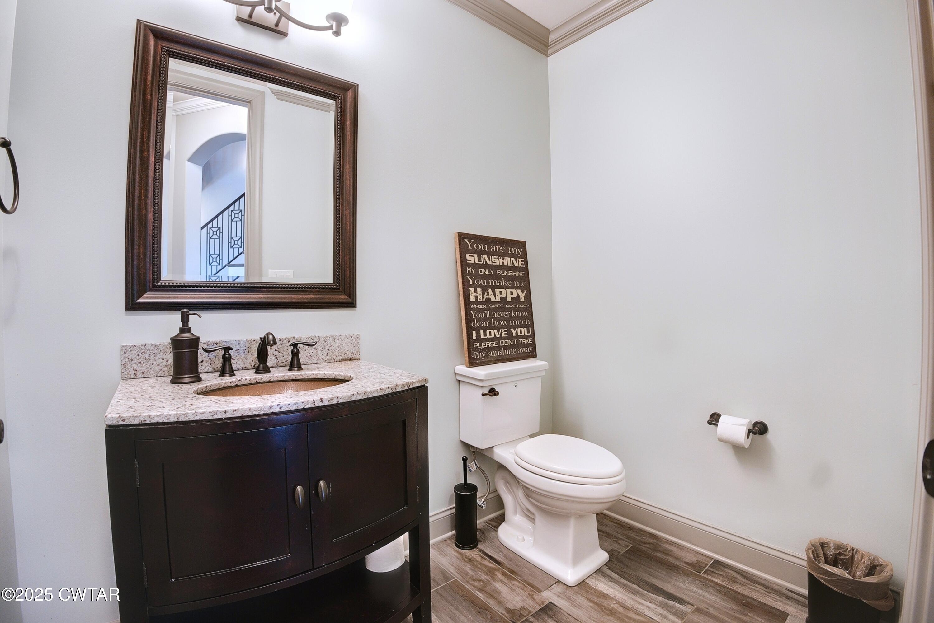963 Ashport Road Jackson, TN 38305 - Photo 38 of 51 a bathroom with a toilet a sink and mirror