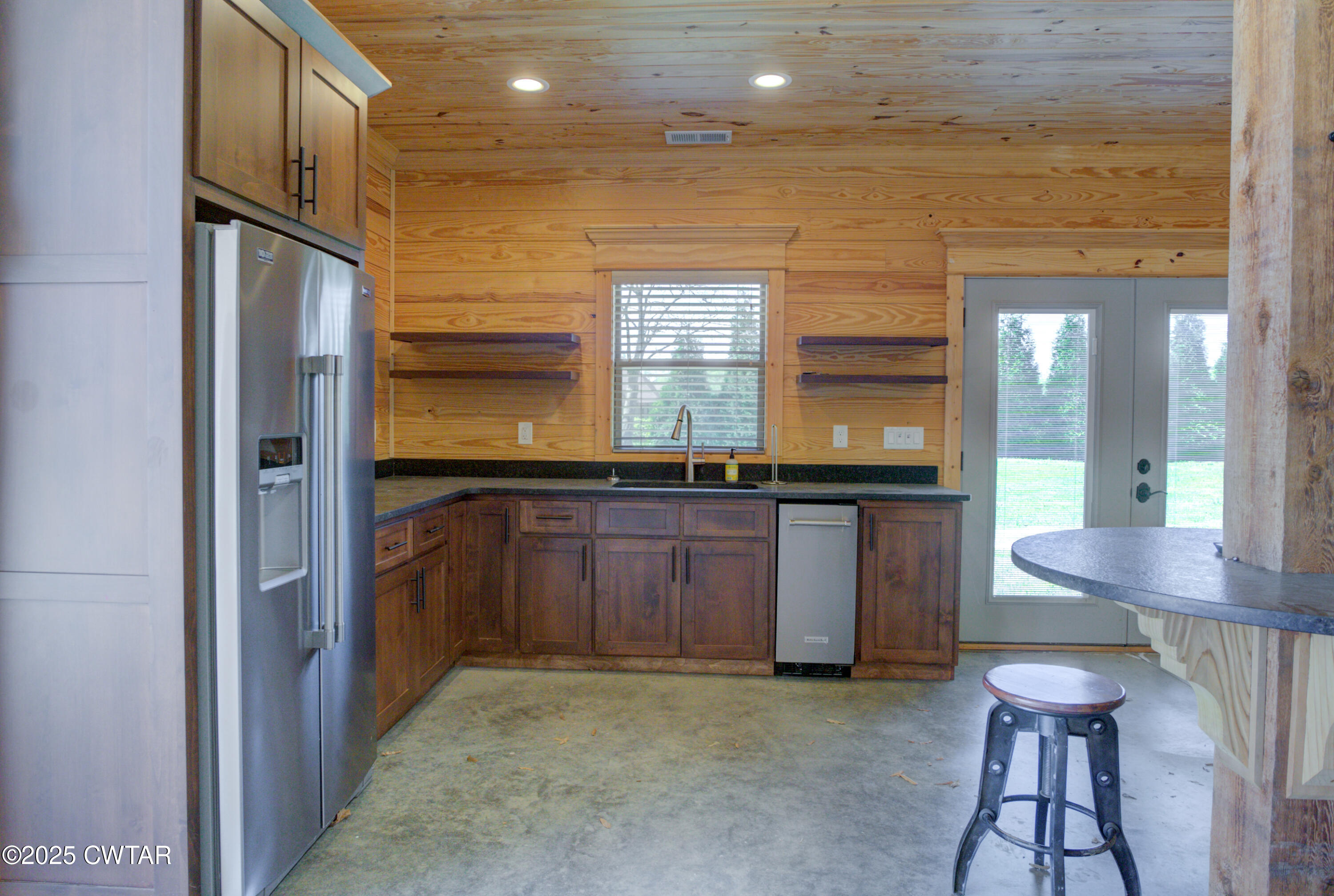 963 Ashport Road Jackson, TN 38305 - Photo 48 of 60 a kitchen with granite countertop a refrigerator and a stove