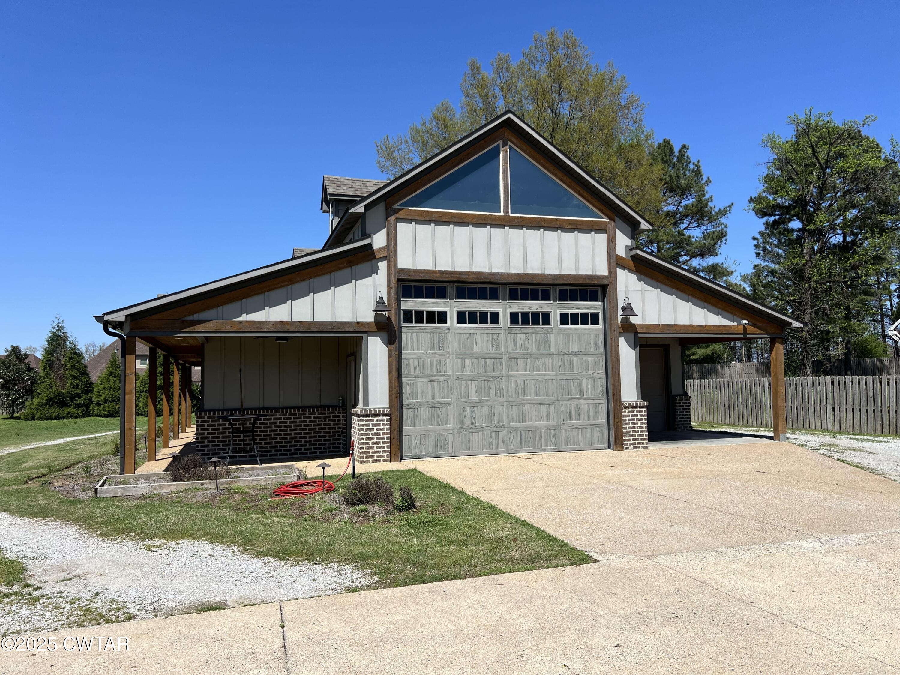 963 Ashport Road Jackson, TN 38305 - Photo 53 of 60 a front view of a house with a yard and garage