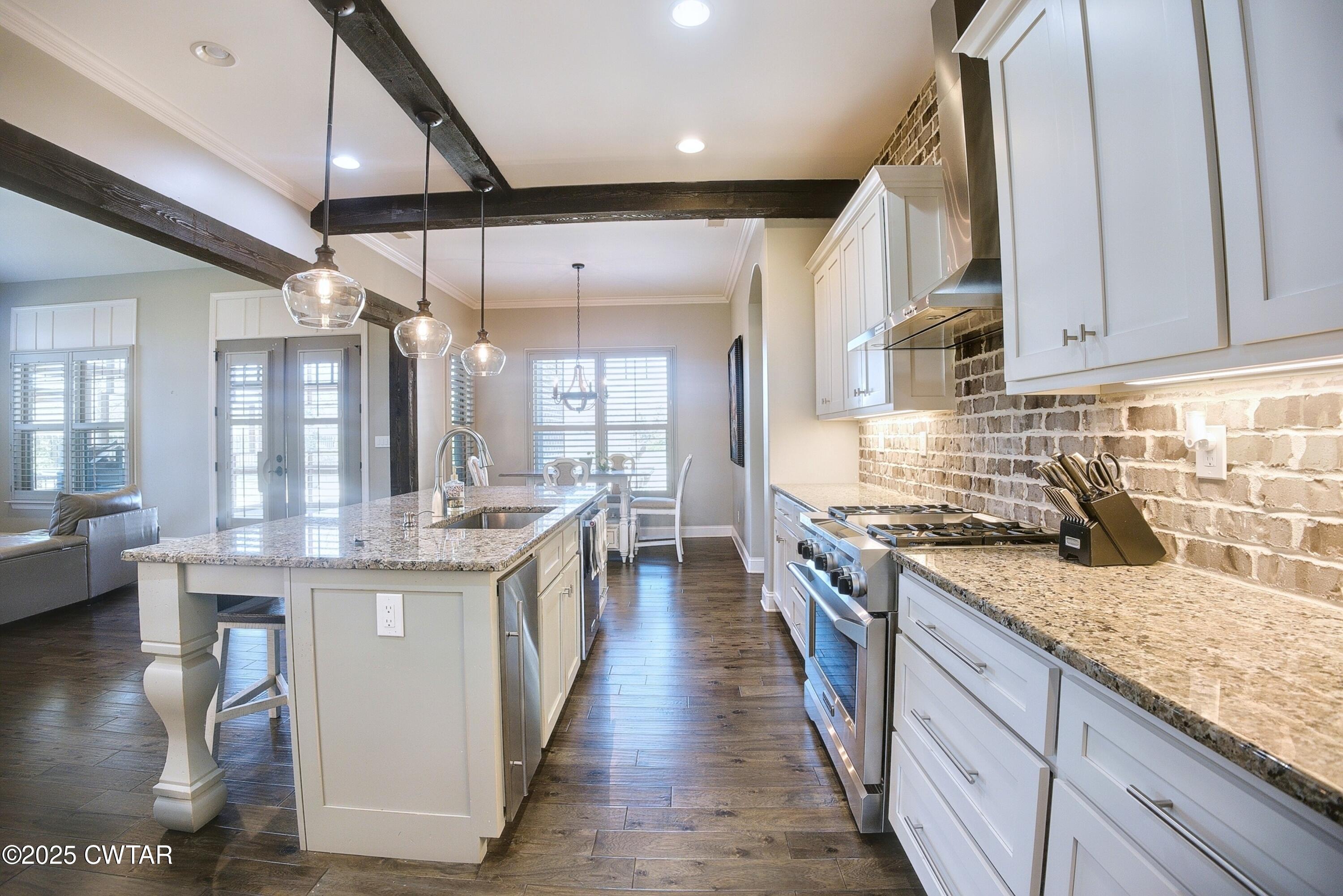 963 Ashport Road Jackson, TN 38305 - Photo 9 of 51 a kitchen with stainless steel appliances granite countertop a stove and a sink
