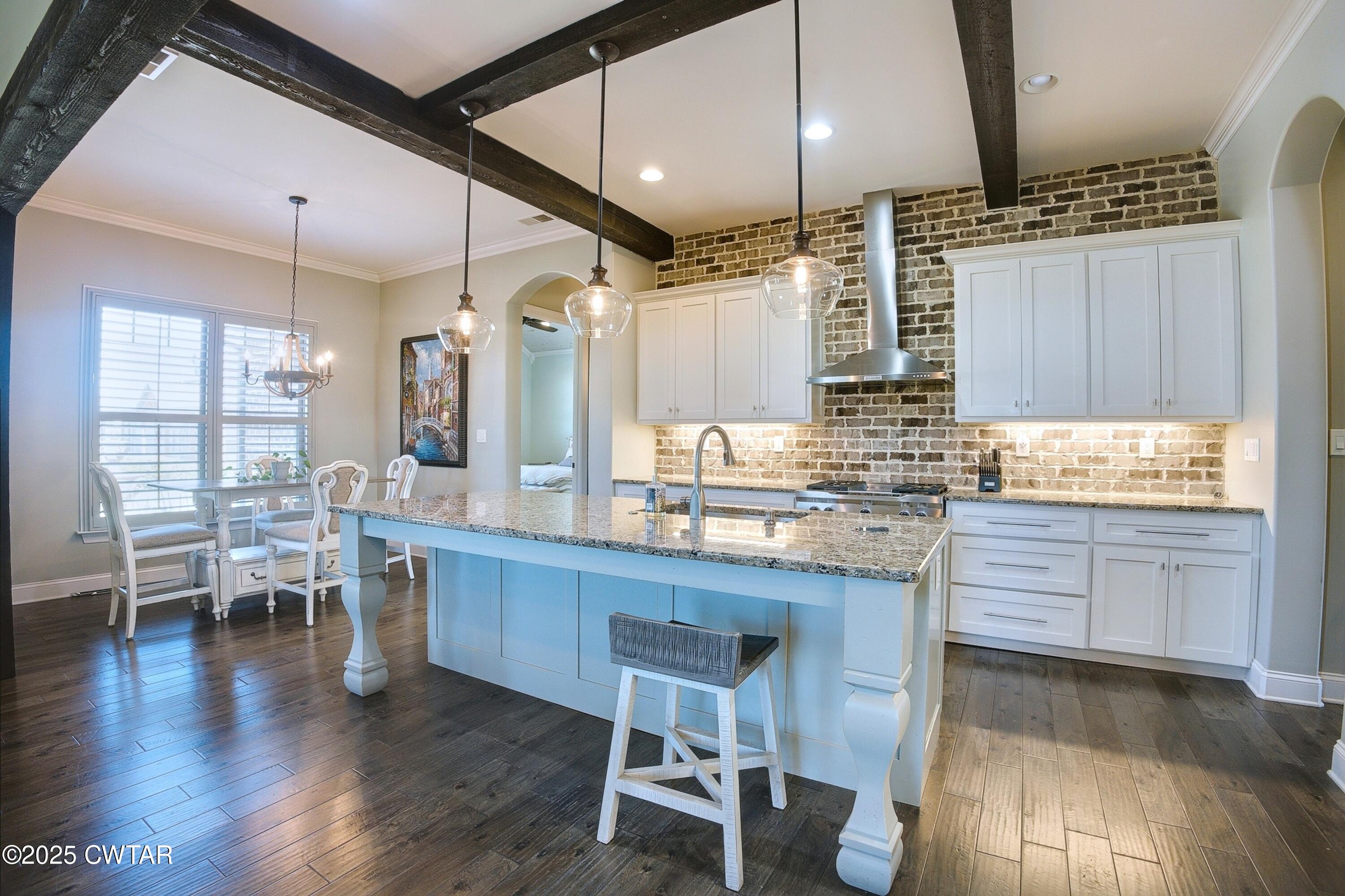 963 Ashport Road Jackson, TN 38305 - Photo 10 of 51 a kitchen with granite countertop sink cabinets and wooden floor