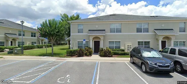 a view of a car parked in front of a brick house